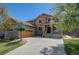 Inviting two-story home showcasing stone accents, manicured lawn, and a charming covered front porch at 25994 E Peakview Pl, Aurora, CO 80016