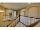 Upstairs hallway overlooking stairway and featuring archways leading to other rooms at 25994 E Peakview Pl, Aurora, CO 80016