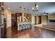 Open kitchen features stainless steel appliances, a breakfast bar, and hardwood floors at 25994 E Peakview Pl, Aurora, CO 80016