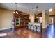 Stylish kitchen boasts stainless steel appliances, a center island with seating, and rich wood cabinetry at 25994 E Peakview Pl, Aurora, CO 80016