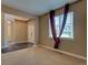 Cozy living room featuring neutral carpet, natural lighting, and hardwood foyer at 25994 E Peakview Pl, Aurora, CO 80016