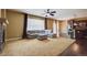 Spacious living room featuring a large sectional sofa, fireplace, and plenty of natural light from the large window at 25994 E Peakview Pl, Aurora, CO 80016