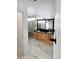 Bright bathroom with double sinks, granite countertops, and a stone-tiled glass shower at 19512 E 58Th Dr, Aurora, CO 80019