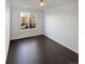 Sun-drenched bedroom has large windows with hardwood floors and white paint at 19512 E 58Th Dr, Aurora, CO 80019