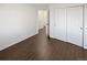 Bedroom featuring hardwood floors, closet, and doors throughout at 19512 E 58Th Dr, Aurora, CO 80019