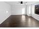 Brightly lit bedroom featuring a ceiling fan and dark wood flooring, complemented by neutral walls at 19512 E 58Th Dr, Aurora, CO 80019