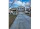 Inviting two-story home with a spacious driveway and manicured lawn under a partly cloudy sky at 19512 E 58Th Dr, Aurora, CO 80019