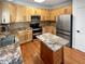 Kitchen with stainless steel appliances, stone countertops, tile backsplash and center island at 19512 E 58Th Dr, Aurora, CO 80019