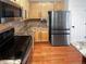Kitchen boasts stainless steel appliances, stone countertops, tile backsplash and gas range at 19512 E 58Th Dr, Aurora, CO 80019