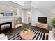 Bright living room featuring a fireplace, dark wood flooring, and modern decor. (Virtually Staged) at 19512 E 58Th Dr, Aurora, CO 80019