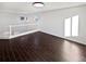 Bright living room features hardwood floors, white walls, and natural light, creating an inviting and spacious ambiance at 19512 E 58Th Dr, Aurora, CO 80019