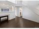 Bright living room featuring a fireplace and dark wood flooring, complemented by neutral walls at 19512 E 58Th Dr, Aurora, CO 80019