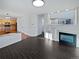 Bright living room boasts an elegant fireplace, modern lighting and an open floorplan into the kitchen and dining area at 19512 E 58Th Dr, Aurora, CO 80019