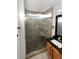 The bathroom features a modern glass-enclosed shower with stone pebble flooring and a built-in shower bench at 19512 E 58Th Dr, Aurora, CO 80019