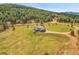 Expansive aerial view of a modern home nestled in a lush landscape, showcasing the property's size and serene setting at 5166 Bear Mountain Dr, Evergreen, CO 80439