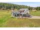 Stunning aerial view of a modern home with a sprawling lawn and outdoor patio, showcasing the property's beautiful design at 5166 Bear Mountain Dr, Evergreen, CO 80439