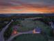 A panoramic aerial view showcases the home's location amongst towering trees, lush greenery and gorgeous views at 5166 Bear Mountain Dr, Evergreen, CO 80439
