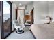 Bright bedroom boasting a comfortable chair, large window and double barn doors at 5166 Bear Mountain Dr, Evergreen, CO 80439