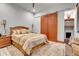 Comfortable bedroom featuring a decorative wooden bed frame, stylish rug and sliding barn doors at 5166 Bear Mountain Dr, Evergreen, CO 80439
