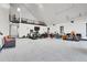 An open concept garage featuring an exercise area and multiple parking spaces for vehicles at 5166 Bear Mountain Dr, Evergreen, CO 80439