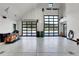 Large garage featuring black framed windows, an epoxy floor, and multiple parking spaces at 5166 Bear Mountain Dr, Evergreen, CO 80439