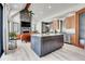 The modern kitchen features a large center island with granite countertop and overlooks the open concept floor plan at 5166 Bear Mountain Dr, Evergreen, CO 80439