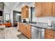 Well-lit kitchen featuring stainless steel appliances, granite countertops, and wooden cabinetry at 5166 Bear Mountain Dr, Evergreen, CO 80439