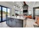 The open concept floor plan has a large kitchen island with bar stool seating, stainless steel appliances and wood floors at 5166 Bear Mountain Dr, Evergreen, CO 80439