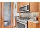 Close-up of a kitchen with stainless steel oven and hood with mosaic tile backsplash at 5166 Bear Mountain Dr, Evergreen, CO 80439
