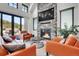 Bright living room showcasing a stone fireplace, comfortable seating, and access to a patio at 5166 Bear Mountain Dr, Evergreen, CO 80439