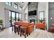 Sun-filled living room features an accent stone fireplace, lots of natural light, and contemporary furnishings at 5166 Bear Mountain Dr, Evergreen, CO 80439