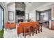 Open-concept living area with modern fireplace, adjacent dining nook and light, wood-look floors at 5166 Bear Mountain Dr, Evergreen, CO 80439