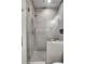 This bathroom features a luxurious walk-in shower with rain shower head and gray textured tiling at 5166 Bear Mountain Dr, Evergreen, CO 80439