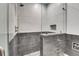 Modern bathroom with a walk-in shower, dual shower heads and decorative inset at 5166 Bear Mountain Dr, Evergreen, CO 80439