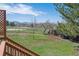 Scenic backyard view from wooden deck with lush green grass and mountain view at 7158 W Roxbury Ave, Littleton, CO 80128