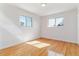 Sun-filled bedroom with hardwood floors and large windows, providing a bright and airy atmosphere at 7158 W Roxbury Ave, Littleton, CO 80128