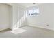Bright bedroom with large windows, neutral carpeting, and a built-in closet at 7158 W Roxbury Ave, Littleton, CO 80128