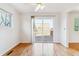 Bright dining area with hardwood floors, a ceiling fan, and sliding glass doors leading to a deck at 7158 W Roxbury Ave, Littleton, CO 80128