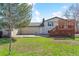 Exterior showing a spacious backyard with green grass and a wooden deck at 7158 W Roxbury Ave, Littleton, CO 80128