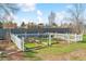 Backyard garden plot with wooden frames and white picket fence provides a great gardening space at 7158 W Roxbury Ave, Littleton, CO 80128