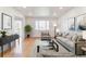 Inviting living room features hardwood floors, neutral-toned furniture, and stylish decor, creating a cozy atmosphere at 7158 W Roxbury Ave, Littleton, CO 80128