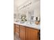 Bathroom featuring a double sink vanity, a large mirror, and decor at 17922 E 104Th Pl # D, Commerce City, CO 80022
