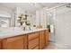 Bathroom featuring a double sink vanity and a shower with glass doors at 17922 E 104Th Pl # D, Commerce City, CO 80022