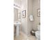 Charming powder room featuring a pedestal sink and stylish decor at 17922 E 104Th Pl # D, Commerce City, CO 80022