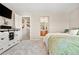 Spacious bedroom leading to a hallway and a bathroom with double sinks at 17922 E 104Th Pl # D, Commerce City, CO 80022