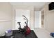 Bright home gym with exercise bike, storage, and sliding closet doors at 17922 E 104Th Pl # D, Commerce City, CO 80022