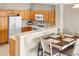 Open kitchen features wood cabinets and breakfast bar that seamlessly blends with dining at 17922 E 104Th Pl # D, Commerce City, CO 80022