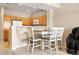 Open kitchen with breakfast bar and wood cabinets for casual dining and functionality at 17922 E 104Th Pl # D, Commerce City, CO 80022