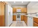 Functional kitchen with white appliances and wood cabinets offers convenience and style at 17922 E 104Th Pl # D, Commerce City, CO 80022