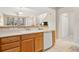 Kitchen area featuring tile floor, wood cabinets, dishwasher, and a double basin sink at 17922 E 104Th Pl # D, Commerce City, CO 80022